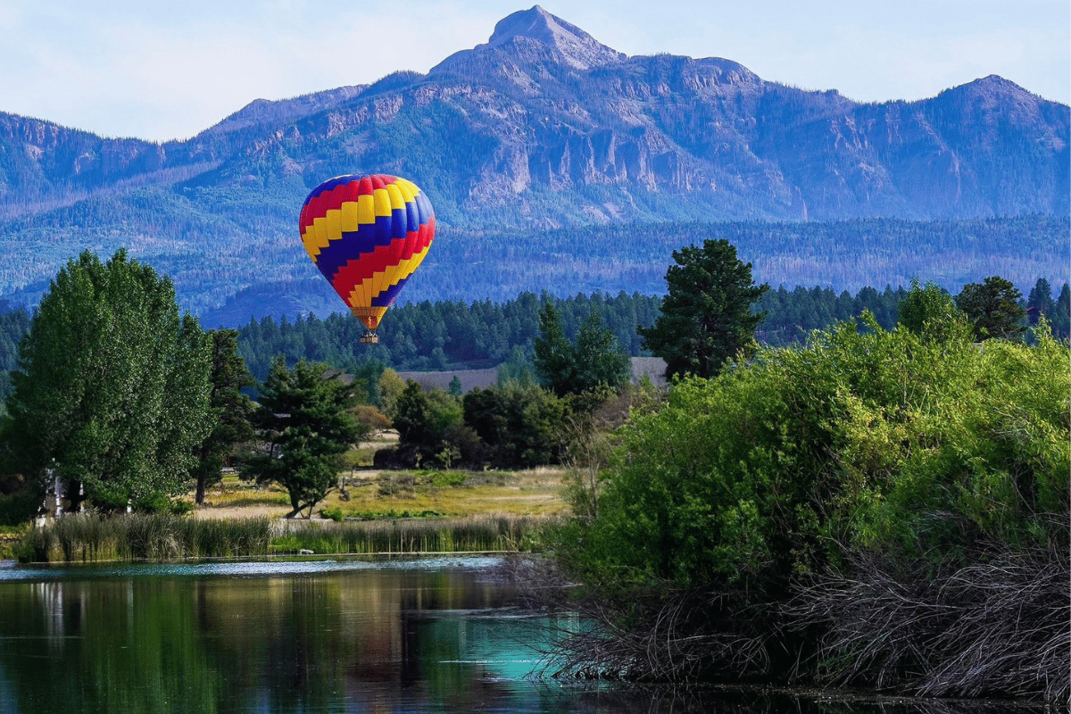 View of hot air balloon over lake in pagosa springs colorado.