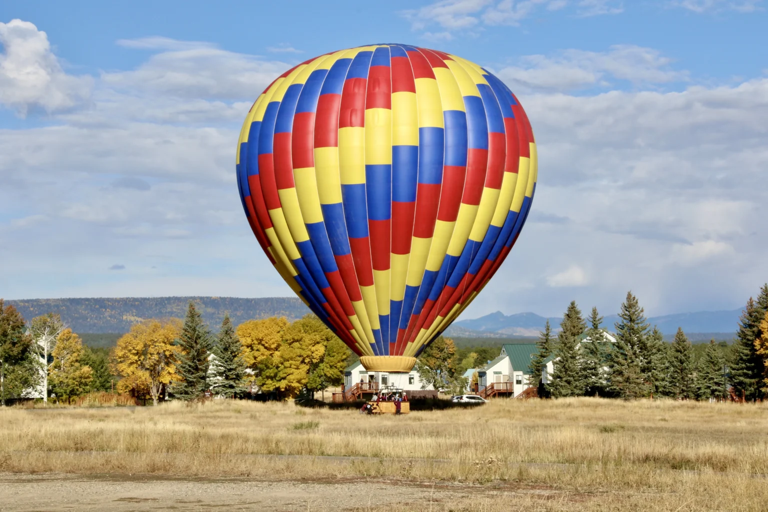 Colorado-hot-air-balloon A colorful hot air balloon about to land in a field in the high desert of Colorado.